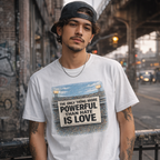 Unisex White t-shirt with text The only Thing more powerful than hate is love from bad bunny’s Super Bowl half time show. 