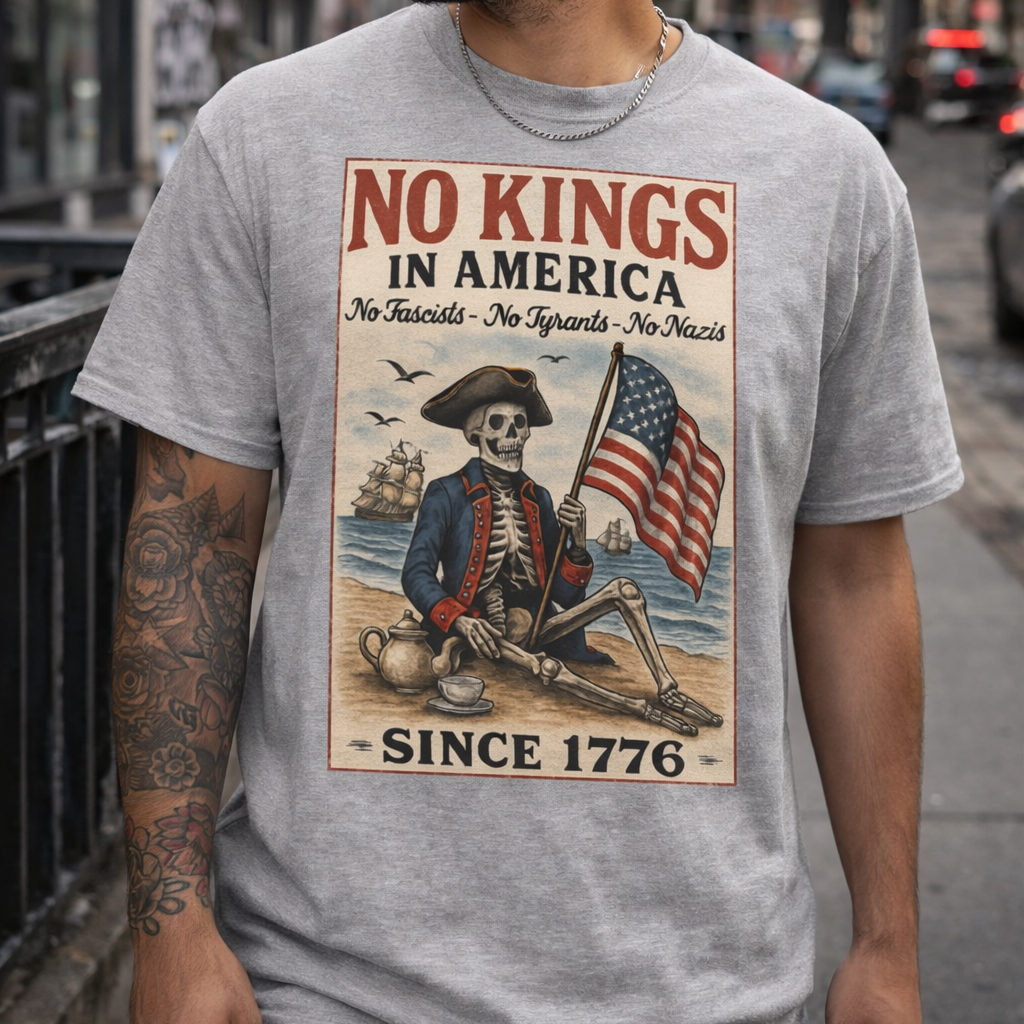 Gray No Kings In America political protest shirt with skeleton graphic, American flag artwork, and protest-style design